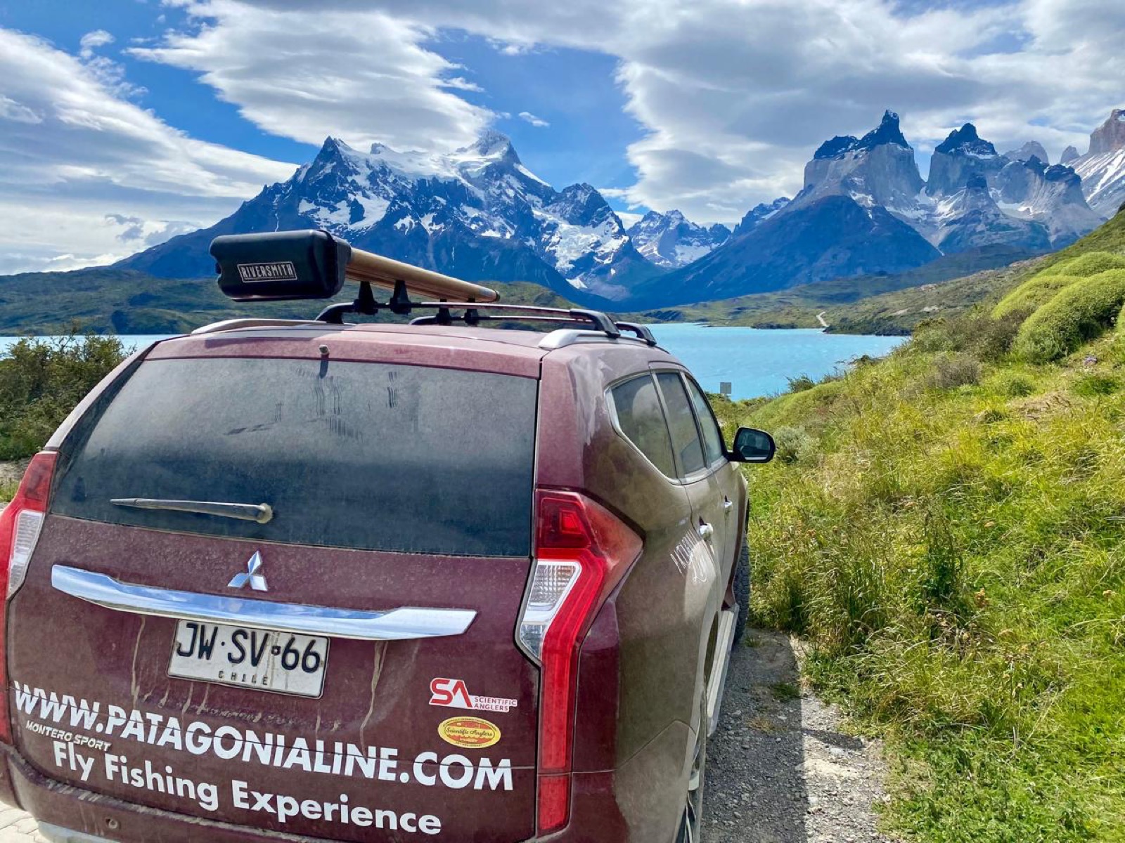 Patagonia Line 4x4 on the road into Torres del Paine, lake and peaks ahead
